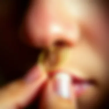 A close-up of a curved nose ring being carefully maintained.