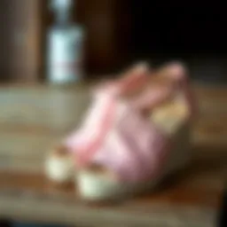 Stylish pink espadrille wedges on a wooden surface