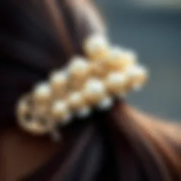 A close-up of a pearl banana clip adorned with intricate designs