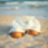 A stylish pair of white swim shorts resting on a sandy beach