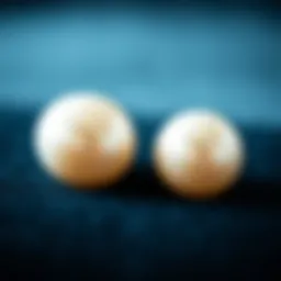 Elegant display of large faux pearl stud earrings on a velvet background