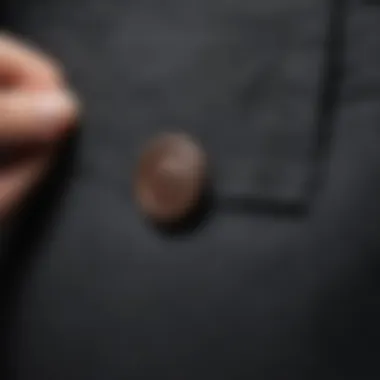 Close-up of a tailored pants button extension showcasing neat stitching and fabric