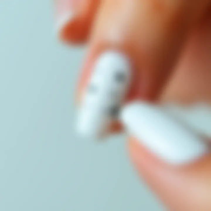 Close-up of Application of White Nail Stickers Close-up of white nail stickers adhered to a polished nail